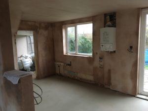 Knock through from original kitchen to create open plan flow - note new RSJ is concealed within newly plasetered ceiling. New boiler now on outside wall.